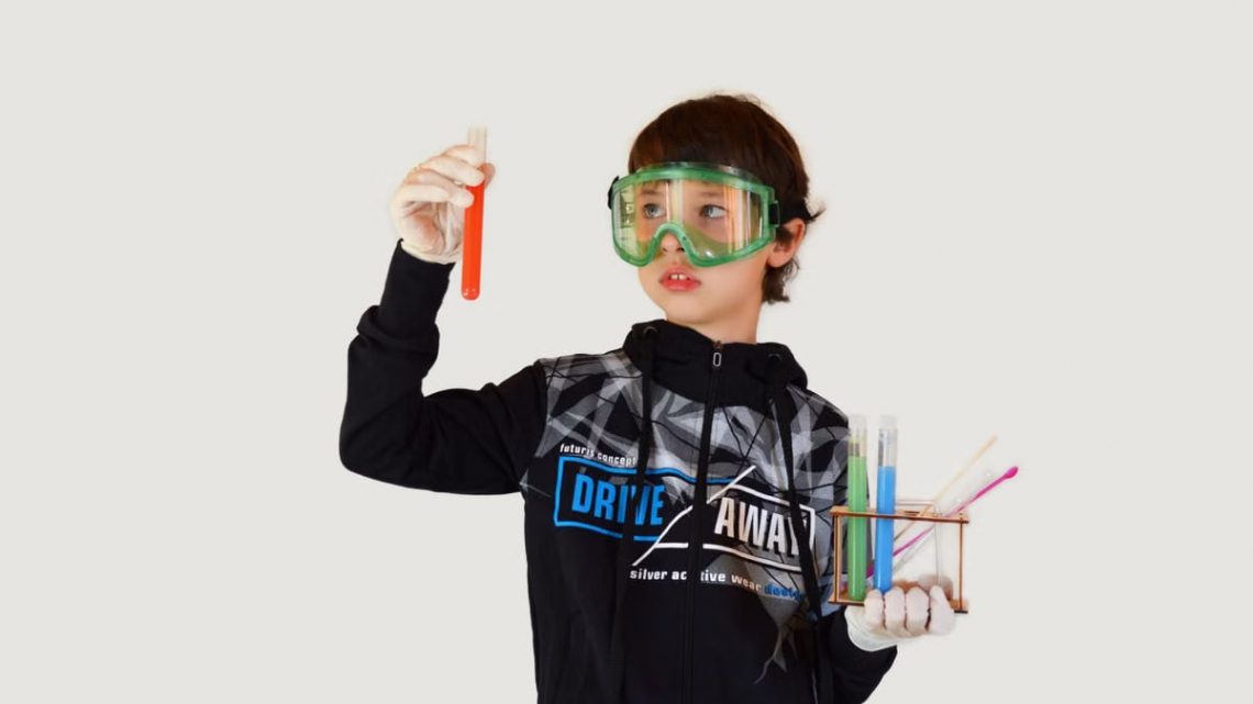 Young male scientist in protective glasses and sterile gloves with colorful liquids in transparent tubes