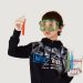 Young male scientist in protective glasses and sterile gloves with colorful liquids in transparent tubes